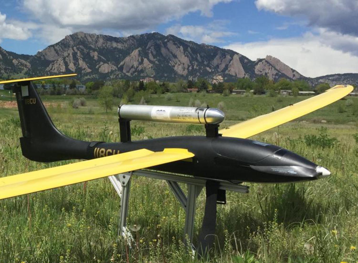 Unmanned flying vehicle parked in a field near ɫ