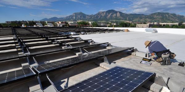 a technician installs solar panels on the roof of the building which houses the University of Colorado Center for Innovation and Creativity in ɫ. 